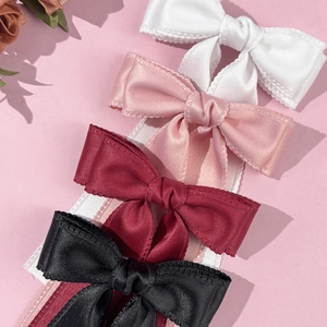 Elegant satin bow hair clips in white, pink, burgundy, and black with scalloped lace edges