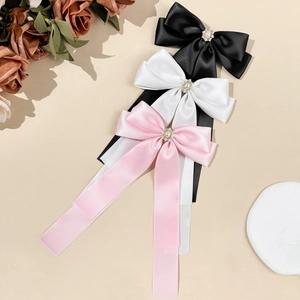Elegant satin bow hair clips in black white and pink with pearl rhinestone accents