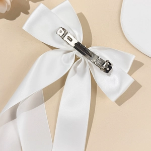 Elegant white satin bow hair clip with long ribbons and premium metal spring clip