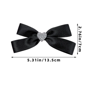 Detail view of black satin bow hair clip with rhinestone heart and size measurements