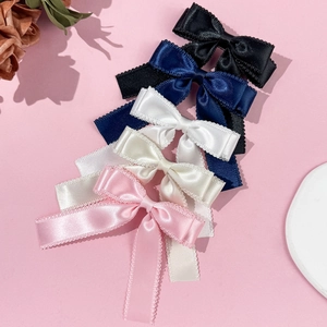 Bow hair clips with lace trim in five colors displayed on a soft pink background