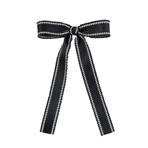 Elegant black bow hair clip with white houndstooth trim and long flowing ribbons