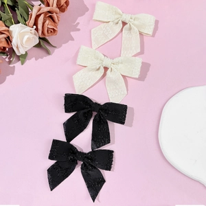 Set di quattro eleganti fermagli per capelli a fiocco in tessuto tweed bianco e nero