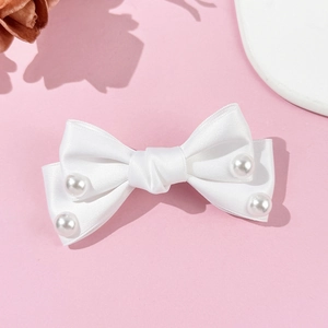 Elegant white satin bow hair clip with faux pearl accents in a sweet aesthetic style