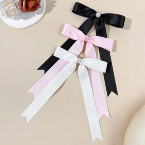 Three elegant satin bow hair clips with pearls in black, pink and white colors