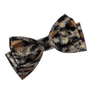 Detail showing high-quality black and gold leopard print jacquard bow hair clip fabric