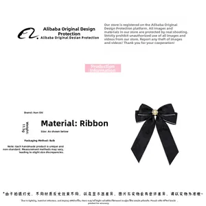 Detail of elegant black ribbon bow hair clip with pearl and rhinestone inlay