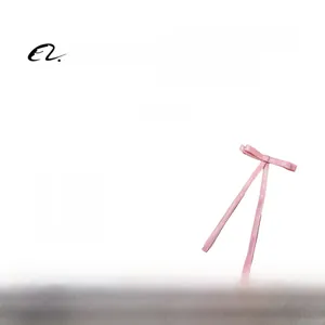 Detail view of pink bow hair clip made of polyester-cotton fabric with weight data