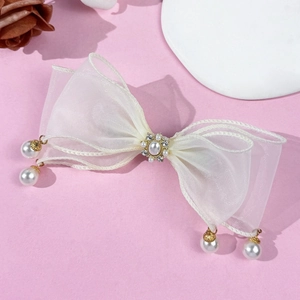 Pince à cheveux élégante en organza blanc avec perles et cristaux sur fond rose doux