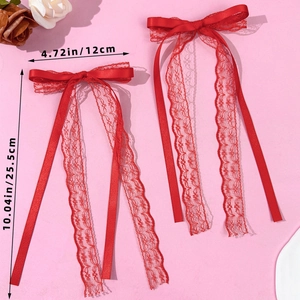 Detail view of red lace bow hair clips showing 4.72in width and 10.04in ribbon length
