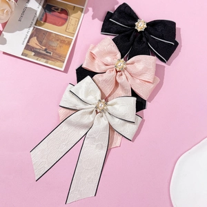 Three-piece set of elegant bow hair clips with pearls and rhinestones in pink, white, and black