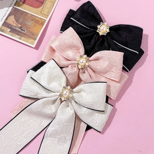Elegant bow hair clips with pearls and rhinestones in black, pink, and white colors