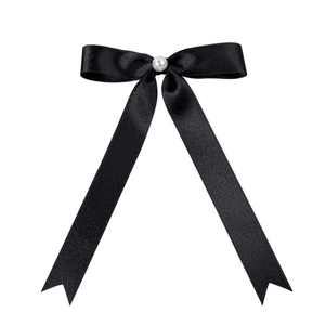 Classic black satin ribbon bow hair clip with a central pearl in a minimalist design