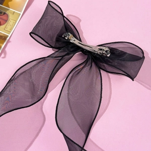 Detailed view of the layered black mesh tulle bow hair clip with silver metal spring fastener