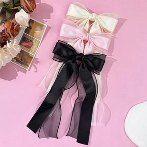 Three-piece set of elegant bow hair clips in cream, pink and black with long mesh ribbons