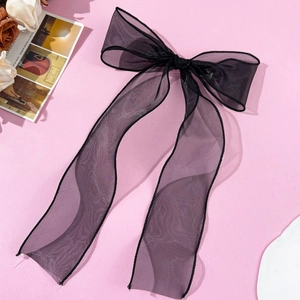 Elegant black mesh bow hair clip with long ribbons and a French romantic aesthetic