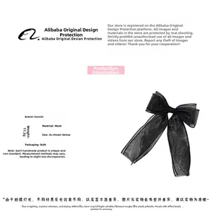 Detail view of the black double-layered mesh bow hair clip with fine stitching edges