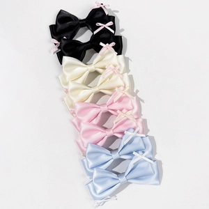 Vertical display of satin bow hair clips featuring layered mini bow details in four colors