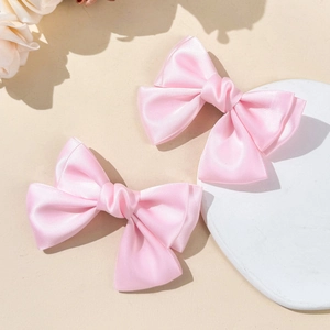 Set of two pink satin ribbon bow hair clips for girls in a sweet and elegant ballet style