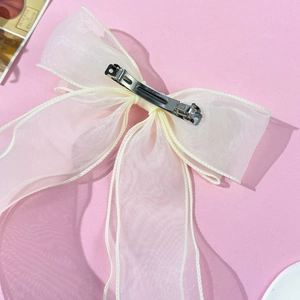 Detail view of the silver metal spring clip on large double-layered organza bow
