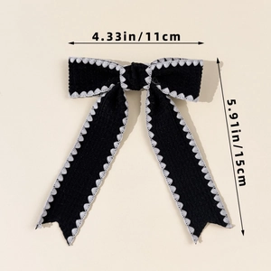 Detail of black bow hair clip with white scalloped edges, size 11x15cm, French vintage style