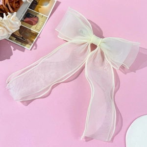 Elegant white double-layered organza bow hair clip with long ribbons on pink background