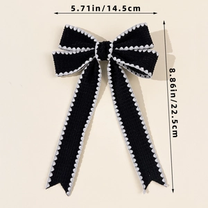 Detailed view of black bow hair clip with lace edges and dimensions 14.5cm by 22.5cm