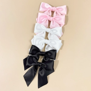 Set of six sweet satin bow hair clips in pink white and black for elegant hairstyling