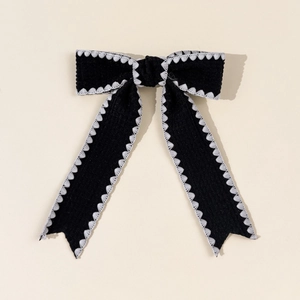 Elegant black bow hair clip with white wavy embroidery edge and long ribbon streamers