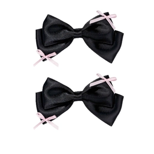 Sweet ballet style black satin bow hair clips with pink accents on a white background
