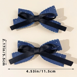 Detail showing dimensions of blue denim and black satin bow hair clips with silver glitter