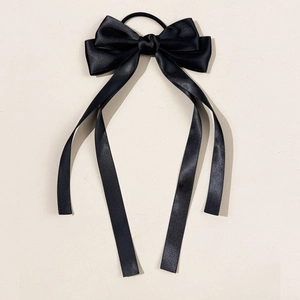 Elegant black satin bow hair tie with long ribbons for stylish ponytail hairstyles