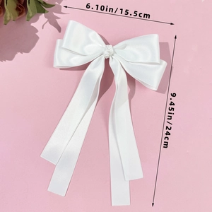Detailed size view of white satin ribbon bow hair clip with 24cm long streamers