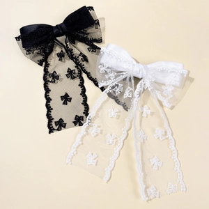 Large lace bow hair clips in black and white with satin finish and elegant embroidery