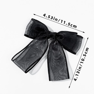 Detail view of black mesh bow hair clip with silver edges, size 11.5cm by 10.5cm