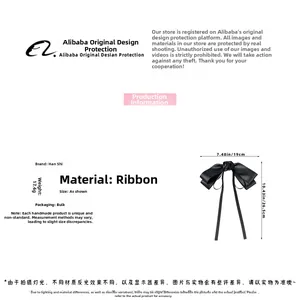 Detailed view of the black ribbon hair clip featuring a delicate 3D rose and long elegant streamers