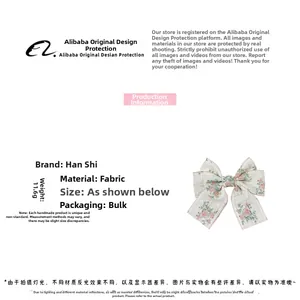 Floral bow hair clip made of cream fabric with pink and green patterns weighing 11.6g