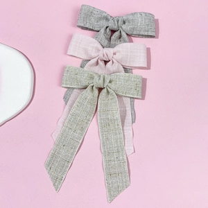 Three-piece linen bow hair clips set with long streamers in grey, pink and gold colors