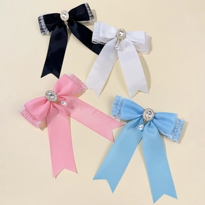 Lace bow hair clips set with rhinestones and teardrop pearls in four assorted colors