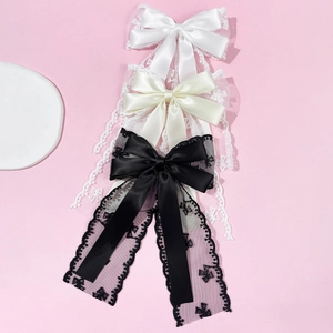 Three-piece lace bow hair clip set in white, cream, and black with long ribbons