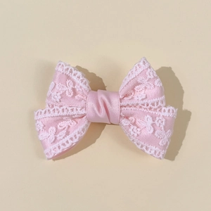 Pink lace bow hair clip for girls featuring delicate embroidery and satin ribbon detail