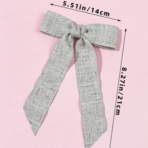 Linen texture bow hair clip detail with long ribbons showing 14x21cm dimensions