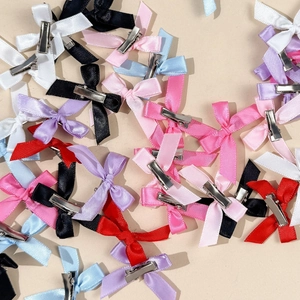 Detailed set of colorful satin bow hair clips showing front and back with metal crocodile clips