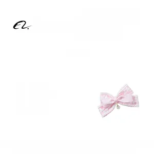 Detailed view of a pink lace bow hair clip with white pearl pendant weighing 15.6g
