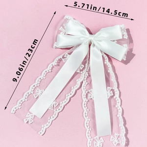 Detailed view of white lace bow hair clip showing dimensions of 23cm length and 14.5cm width