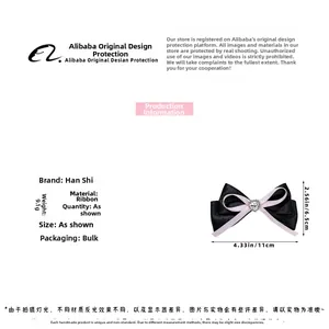 Detail view showing a black and pink ribbon bow hair clip with a crystal heart, 11x6.5cm size