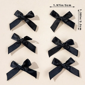 Set of 6 black ribbon bow hair clips showing 5cm width dimensions on beige background