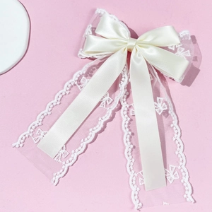 Elegant cream lace bow hair clip with satin ribbons for women on a pink background