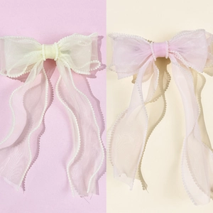 Elegant tulle bow hair clip with pearl edges in soft cream and pink colors
