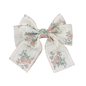 Elegant floral bow hair clip with pink rose patterns and translucent polka dot fabric texture